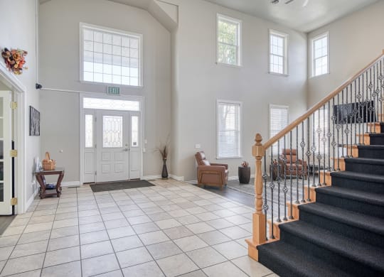 a view of the entryway of a house with a tiled floor and a staircase