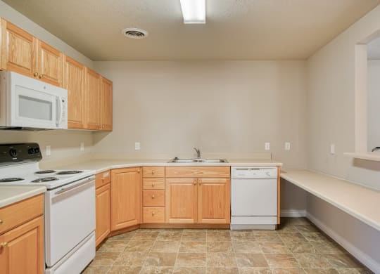 a kitchen with white appliances and wooden cabinets