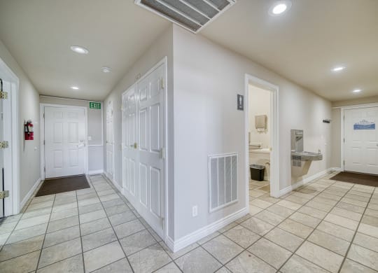 a hallway with a tiled floor and white walls