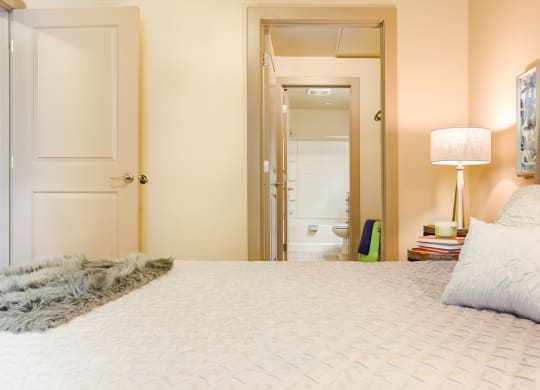 a bedroom with a large bed and a mirror in the closet at Sugar House Apartments By Urbana, Salt Lake City, UT, 84105