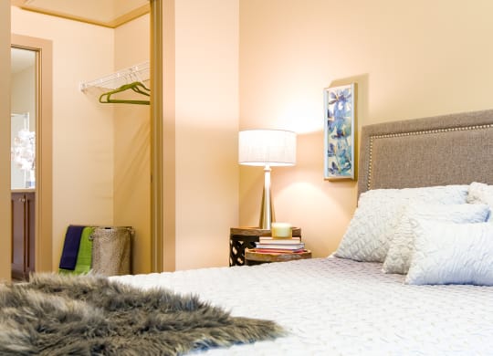 a bedroom with a large bed and a mirror at Sugar House Apartments By Urbana, Salt Lake City, UT, 84105