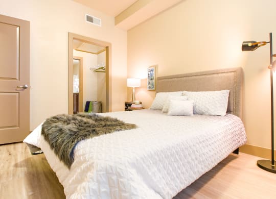 a bedroom with a large bed and a rug at Sugar House Apartments By Urbana, Salt Lake City, UT, 84105