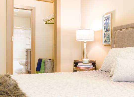 a bedroom with a bed and a mirror and a bathroom at Sugar House Apartments By Urbana, Salt Lake City, UT, 84105