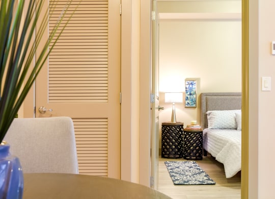 a bedroom with a bed and a table and a chair at Sugar House Apartments By Urbana, Salt Lake City, UT, 84105