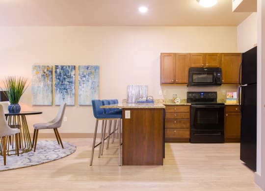 a kitchen and dining room with a table and chairs at Sugar House Apartments By Urbana, Salt Lake City, UT, 84105