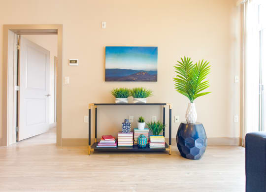 a living room with a table and a vase with plants at Sugar House Apartments By Urbana, Salt Lake City, UT, 84105