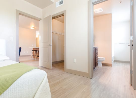 a room with a bed and a bathroom and a closet at Sugar House Apartments By Urbana, Salt Lake City, UT, 84105