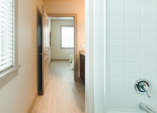 a view of a bathroom and a hallway with a door open at Sugar House Apartments By Urbana, Salt Lake City, UT, 84105