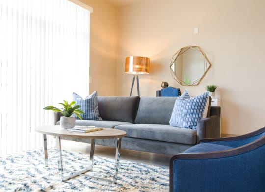 a living room with a gray couch and blue chairs at Sugar House Apartments By Urbana, Salt Lake City, UT, 84105
