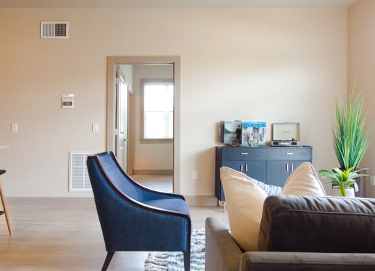 a living room with a couch chair and desk in a 555 waverly unit at Sugar House Apartments By Urbana, Salt Lake City, UT, 84105
