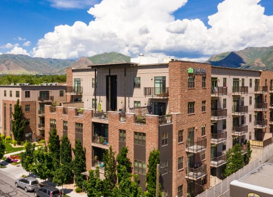 an aerial view of a large apartment complex with a mountain in the background at Sugar House Apartments By Urbana, Salt Lake City, UT, 84105