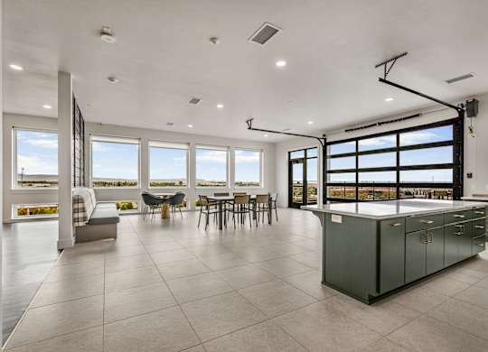 A modern kitchen with a large island and a view of the ocean.