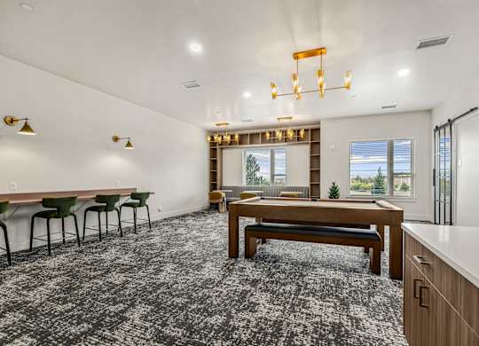 A room with a long table and chairs.