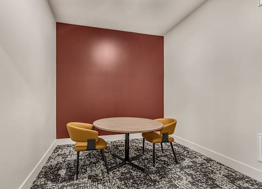 A round table with four chairs around it in a room.