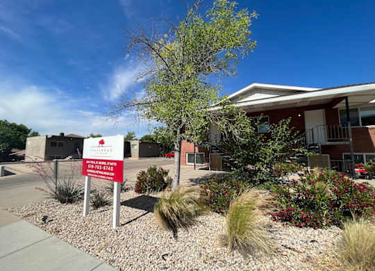 A building with a red sign in front of it.