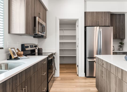 a kitchen with white countertops and wooden cabinets