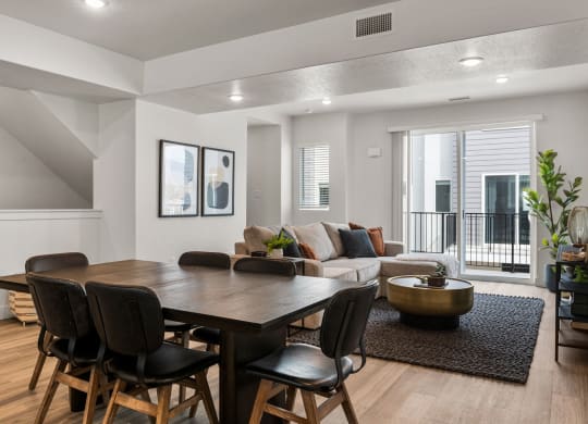 a living room with a dining room table and chairs