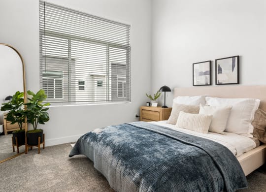 a bedroom with a large bed and a large window