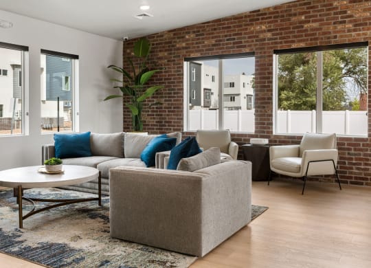 a living room with a brick wall and large windows