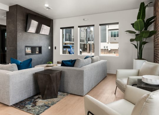 a living room with white furniture and a fireplace