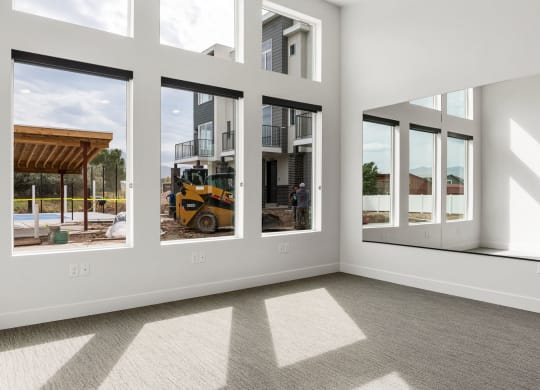 an empty room with a bulldozer in the background