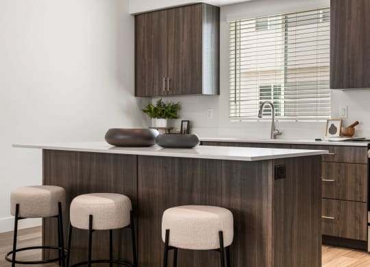 a kitchen with an island and three stools