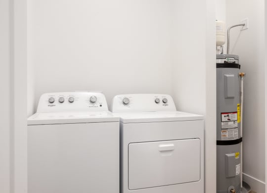 a washer and dryer in a room with a refrigerator
