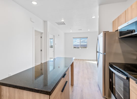a kitchen with an island and stainless steel appliances