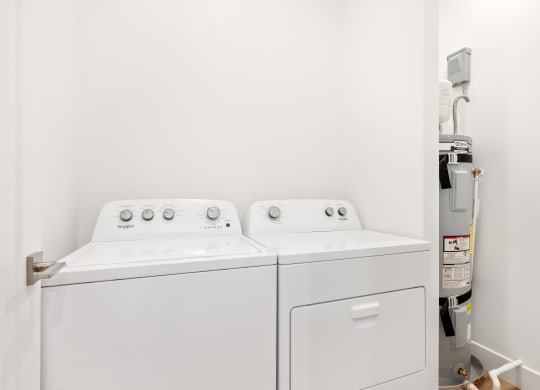 a washer and dryer in a room with a white wall