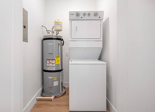 a white washer and dryer in a room with white walls