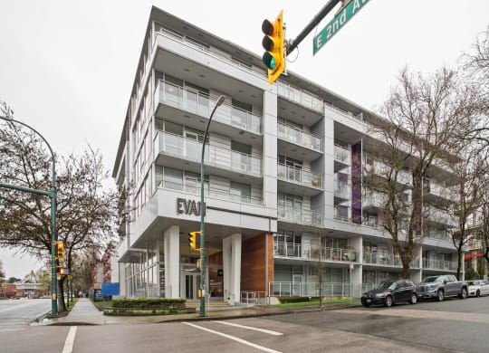 a large apartment building with cars parked in front of it