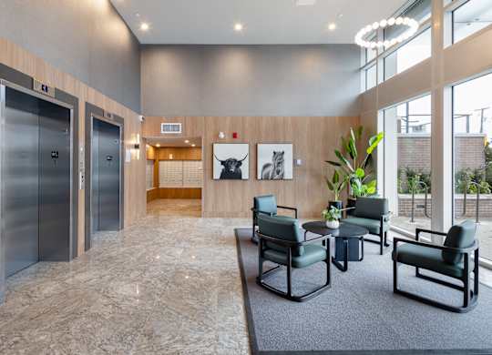 A spacious waiting area with two elevators and a seating area.