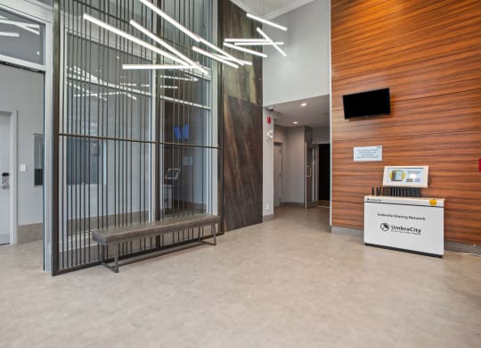 the lobby of a building with a large glass window and a reception desk