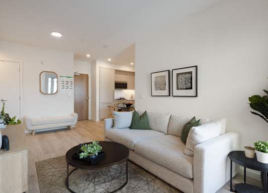 A living room with a white couch and a coffee table.