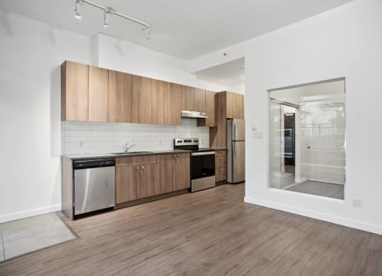 a kitchen with wooden cabinets and stainless steel appliances and a glass door