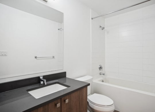 a bathroom with a sink toilet and a tub