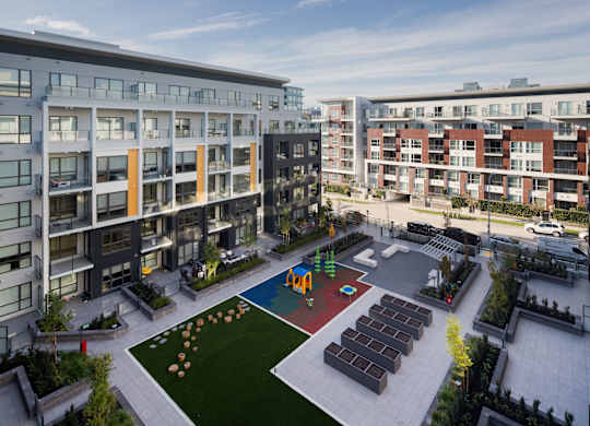 A view of a courtyard with a playground and apartment buildings.