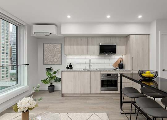 A modern kitchen with a dining table and chairs.