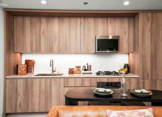 a kitchen with wooden cabinets and a black table