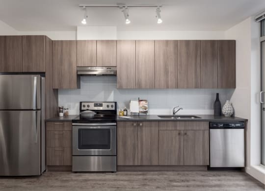 a kitchen with stainless steel appliances and wooden cabinets