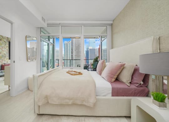 a bedroom with a bed and a large window