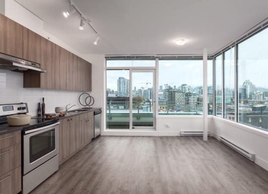 a kitchen with a large window and a city view