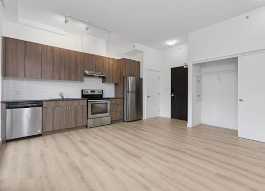 A kitchen with wooden cabinets and stainless steel appliances.