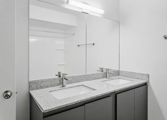 A bathroom with a sink and mirror.