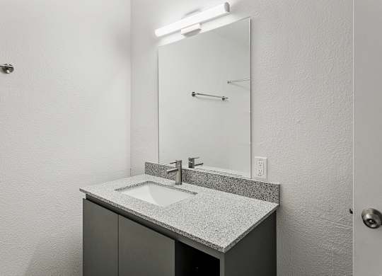 A bathroom with a sink and mirror.
