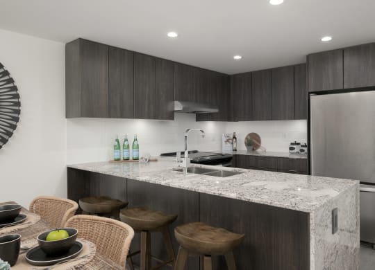 a kitchen with a marble counter top and a sink