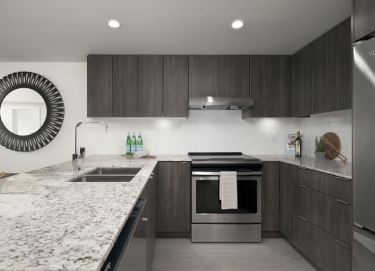 a modern kitchen with marble counter tops and wooden cabinets