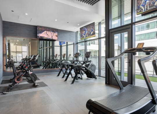 a room filled with lots of cardio equipment and a treadmill