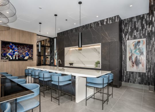 a kitchen with a large center island with a marble countertop