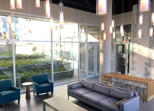 a lounge area with couches and chairs in the lobby of a building